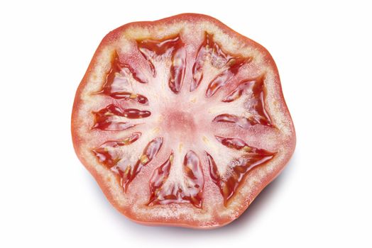 A fresh tomatoe cut isolated over a white background.