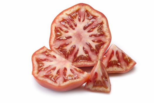 A fresh tomatoe cut isolated over a white background.