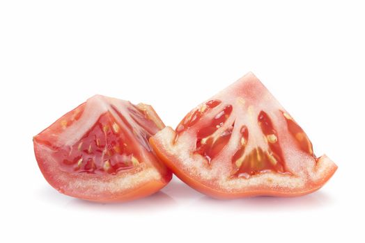 A fresh tomatoe cut isolated over a white background.