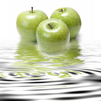 Fresh smith apples reflected on water on a white background.