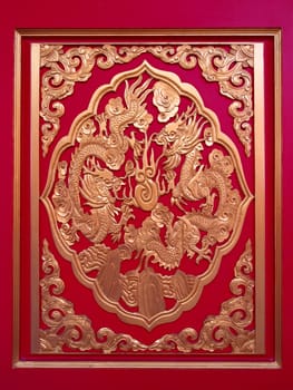  Golden Chinese Dragon in red wall ,temple in thailand