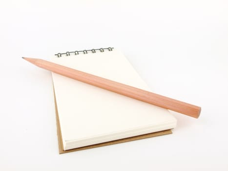 Isolated pencil with notebook on white  