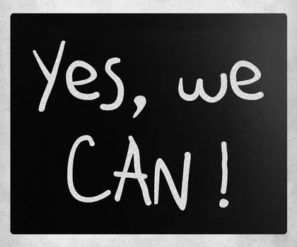 "Yes, we can!" handwritten with white chalk on a blackboard