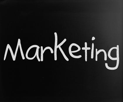 The word "Marketing" handwritten with white chalk on a blackboard