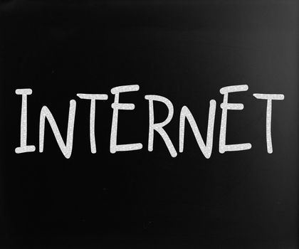 The word "Internet" handwritten with white chalk on a blackboard