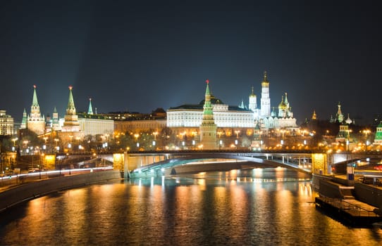 Kind to the Moscow Kremlin and Moskva River in winter night. Russia