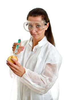 Female scientist in lab coat with syringe and apple. Isolated on white.