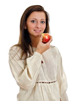 Female in rural clothes eating apple. Isolated on white.