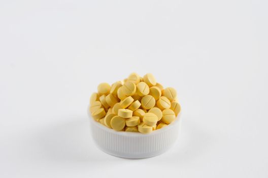 Many yellow medicine  on the white background