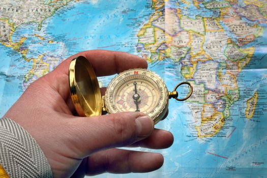 compass in the hand, map in the background
