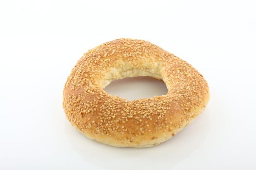 Close up of sesame bagel over white
