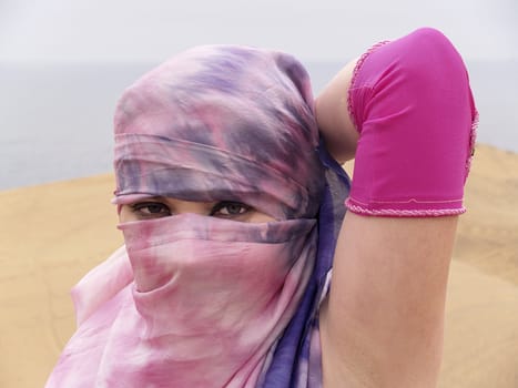 Veiled woman at desert