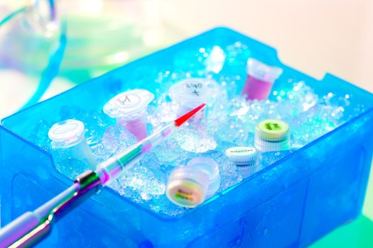 Automatic pipette over reaction tube in a box full of ice