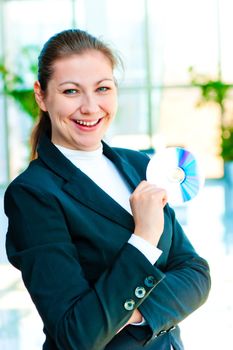 Girl in a business suit holding his hand in compact disc