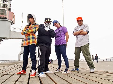 Group of rappers posing at the city of Valparaiso, Chile