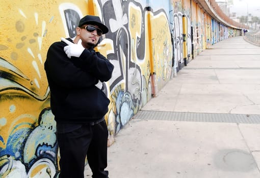 Portrait of a urban rapper near a wall