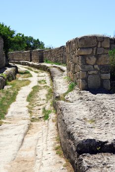 Closeup of road and stone wall in ancient Karaite town, Crimea