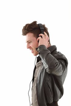 Young adult male with headset listening music isolated on white background