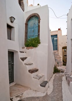 Village street with staircases and entrance doors in Santorini island