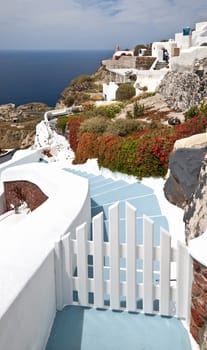 Sea view in Santorini island with blue staircase to the buildings on the cliff
