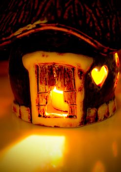 Candle in the small ceramic house