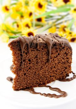 Gingerbread on plate. Yellow flowers in background