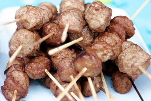 Peaces of meat on skewers and they are fried like stringed on hot coals