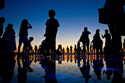 People reflections on colorful sunset in Zadar, Croatia