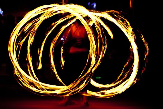 Fire dancer at night turning torch