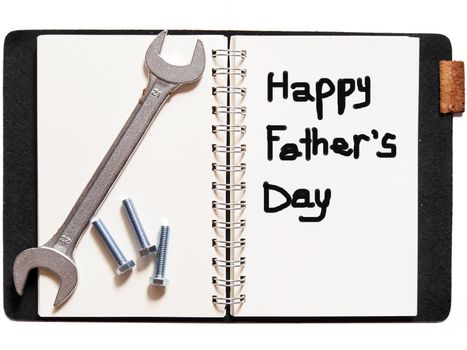 "happy father's day"in notebook with wrench for your father