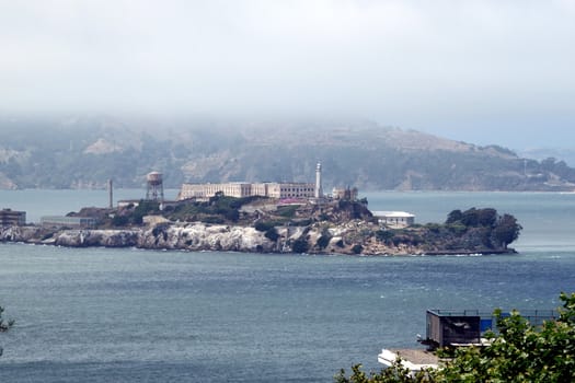 The prison island Alcatraz with a fog bank over it.