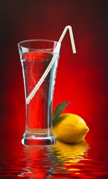 mineral water and lemon on a colored background