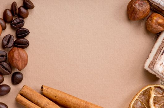 Close up of coffee, cinnamon, nuts, sweet on old paper material. Place for text.