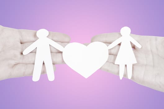 Paper family in hand with a big hearth isolated on white