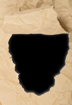 ripped white paper against a black background