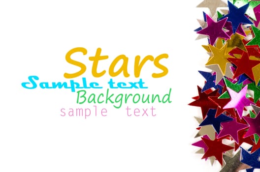 Christmas decoration of colored confetti stars against white background