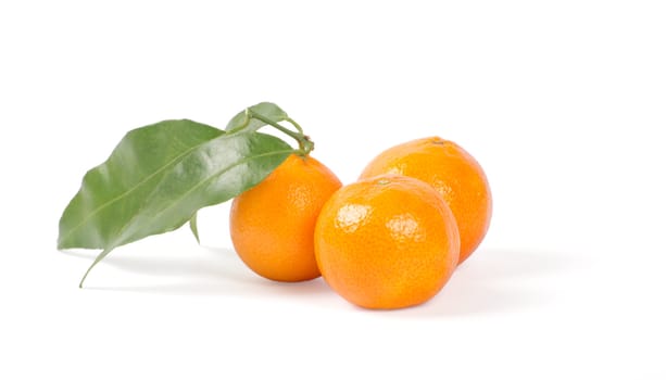 Tangerines with green leaves isolated on white