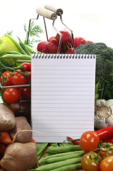 Ruled note pad and a variety of vegetables