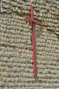 Wooden cross with Brick Background
