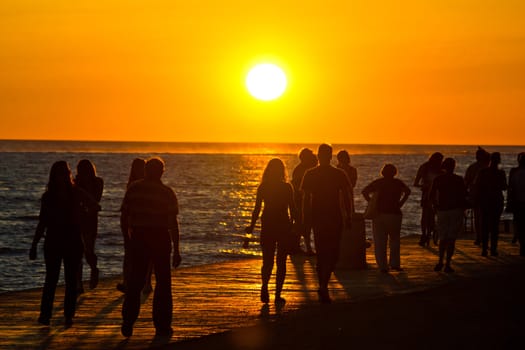 People walking on waterfront on sunset in Zadar, Dalmatia, Croatia