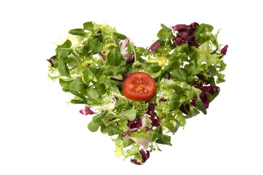 A heart of salad and tomato. Metaphor of healthy nutrition and love.