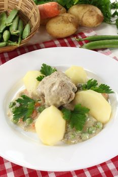 cooked meatballs with capers, peas and carrots