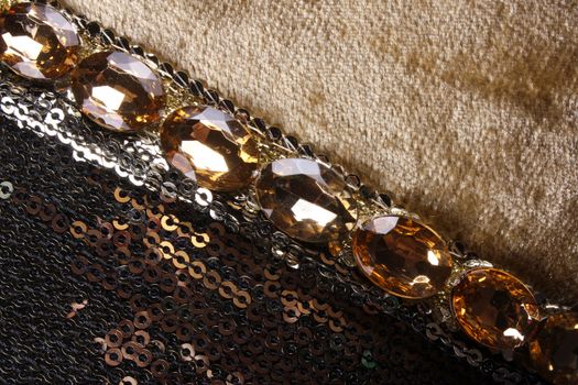 A beautiful pattern of sequins and gemstones on a classic fabric.