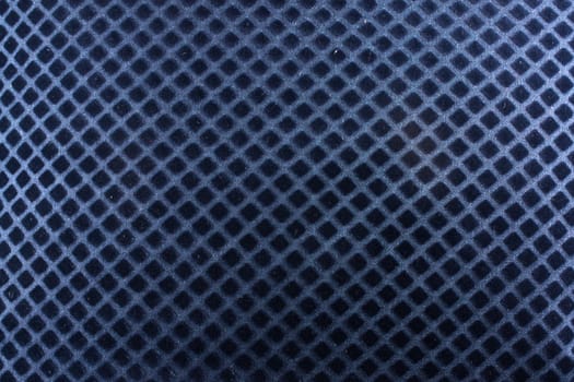 A background of a blue fabric with a pattern of diagonal lines crossing each other.