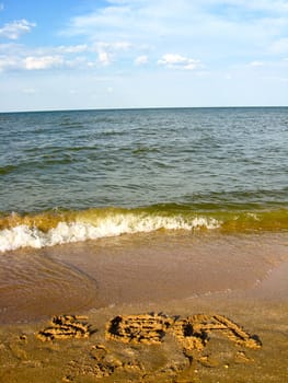 The image of inscription on the sea sand