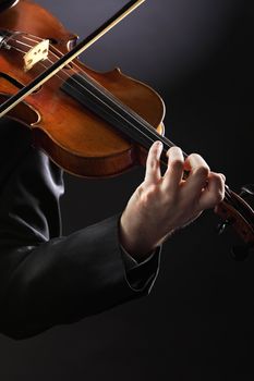 the violinist: Musician playing violin on dark background