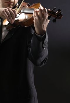 the violinist: Musician playing violin on dark background