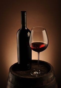 red wine bottle and wine glass on wodden barrel