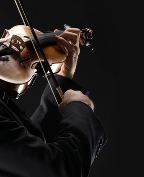 the violinist: Musician playing violin on dark background