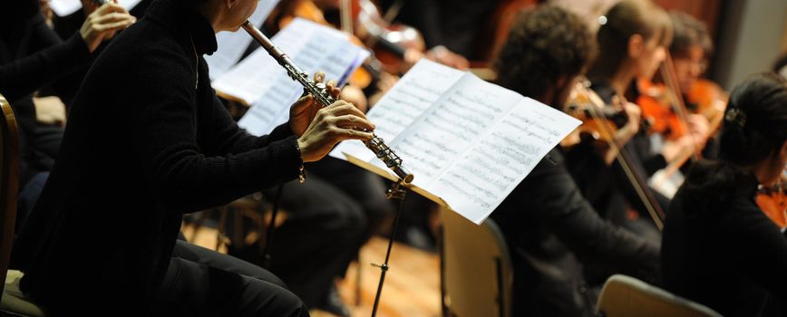 Woman playing flute during a classical concert music